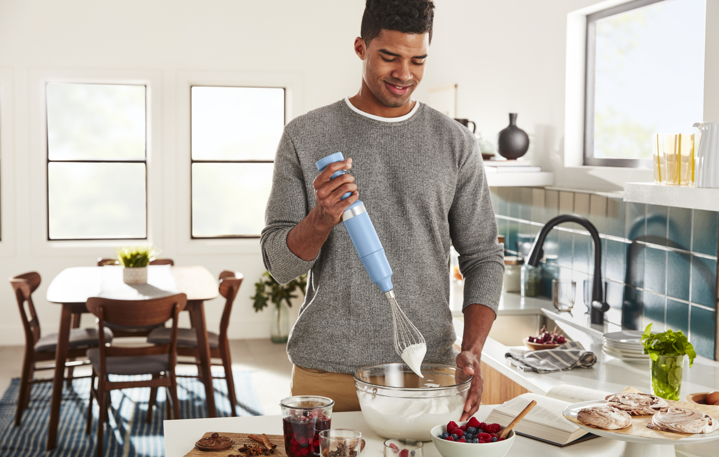 Man whipping cream with a hand blender Man whipping cream with a hand blender