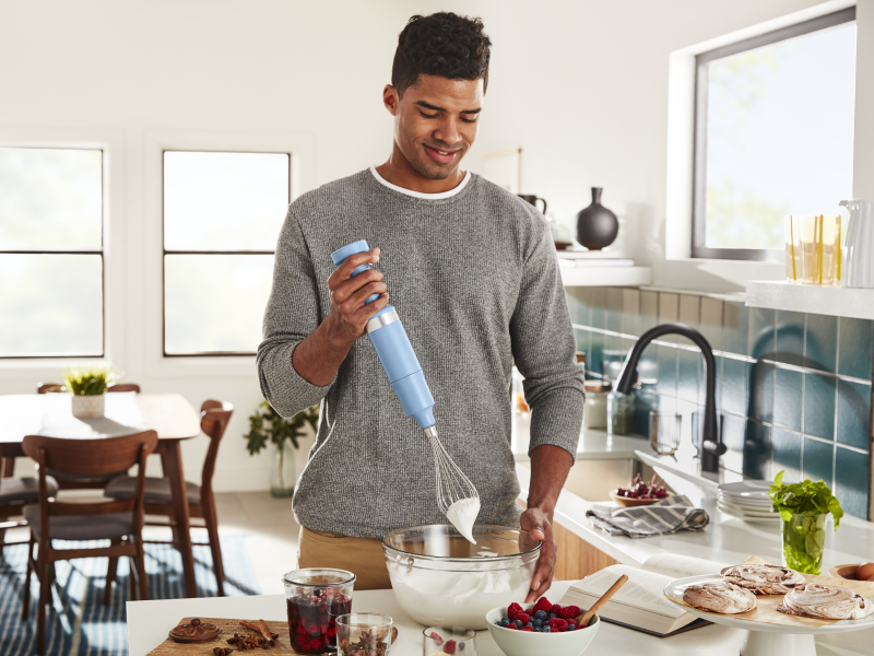 Man whipping cream with a hand blender Man whipping cream with a hand blender