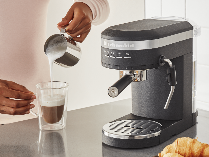 Steamed milk being poured over espresso Steamed milk being poured over espresso