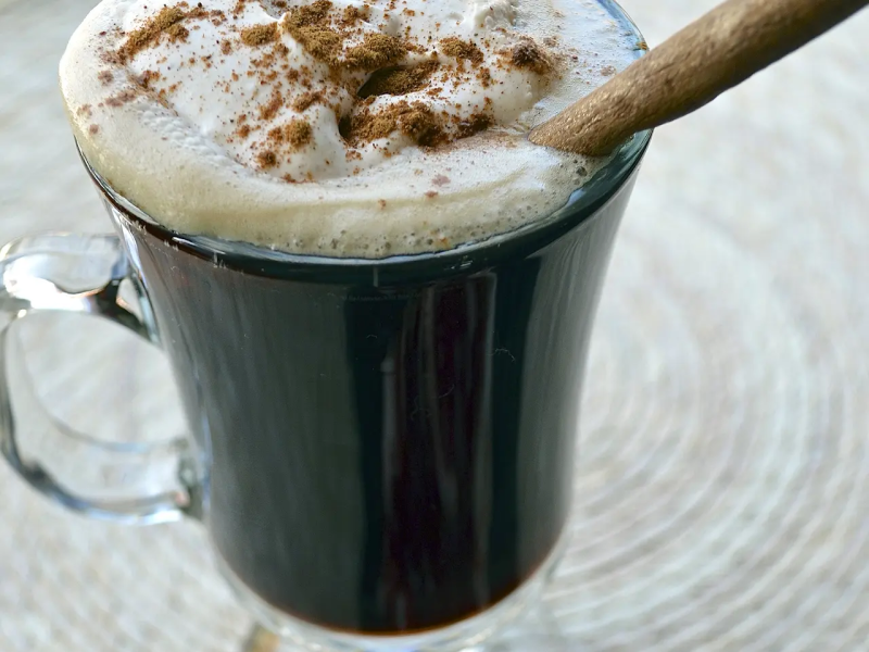 Hot Irish coffee topped with whipped cream and cinnamon Hot Irish coffee topped with whipped cream and cinnamon