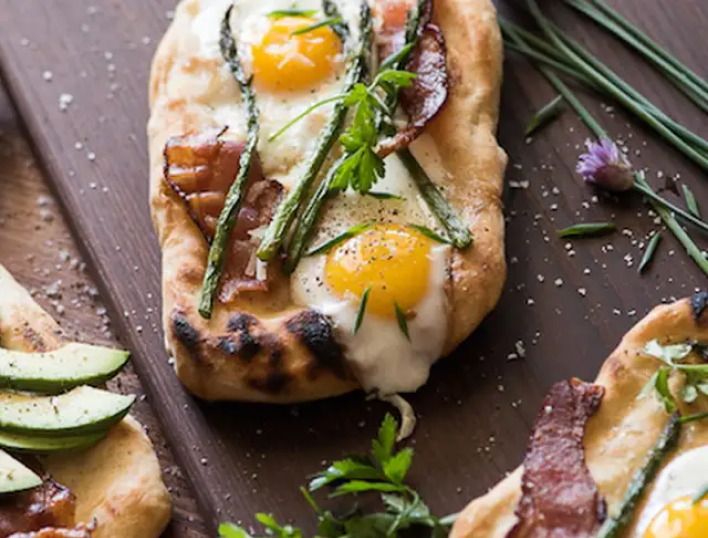 Brunch pizza topped with fried eggs and asparagus Brunch pizza topped with fried eggs and asparagus