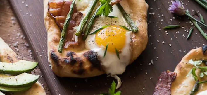 Brunch pizza topped with fried eggs and asparagus Brunch pizza topped with fried eggs and asparagus
