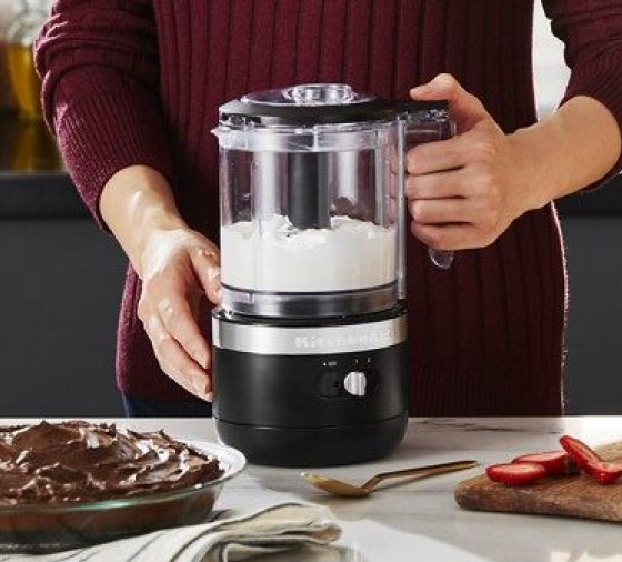 Woman whipping cream with black KitchenAid® food chopper