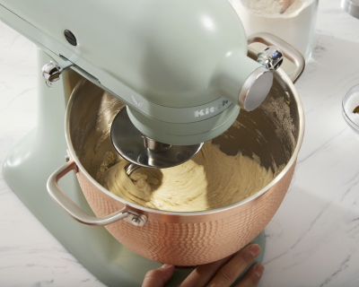 KitchenAid® stand mixer with dough hook mixing dough