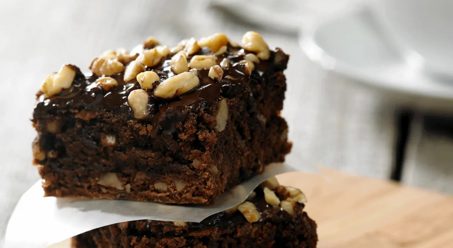 Chocolate and walnut brownies topped with chopped nuts Chocolate and walnut brownies topped with chopped nuts
