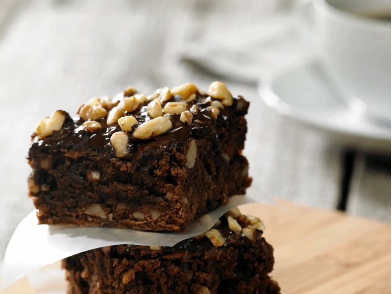 Chocolate and walnut brownies topped with chopped nuts Chocolate and walnut brownies topped with chopped nuts