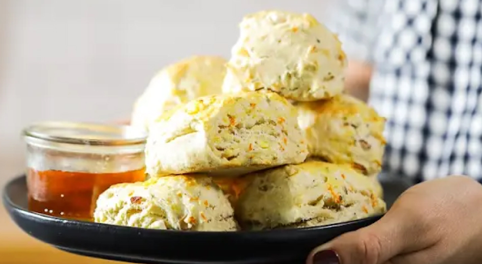 Person holding plate of homemade biscuits