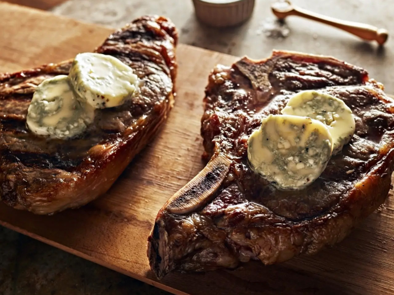 Ribeye steaks with blue cheese butter on top