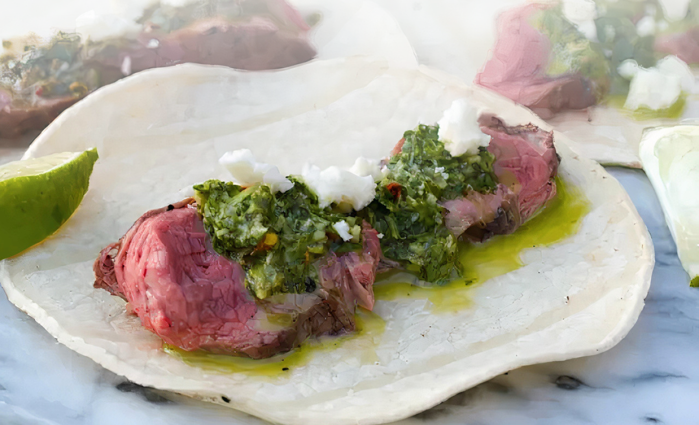 Steak tacos topped with chimichurri Steak tacos topped with chimichurri