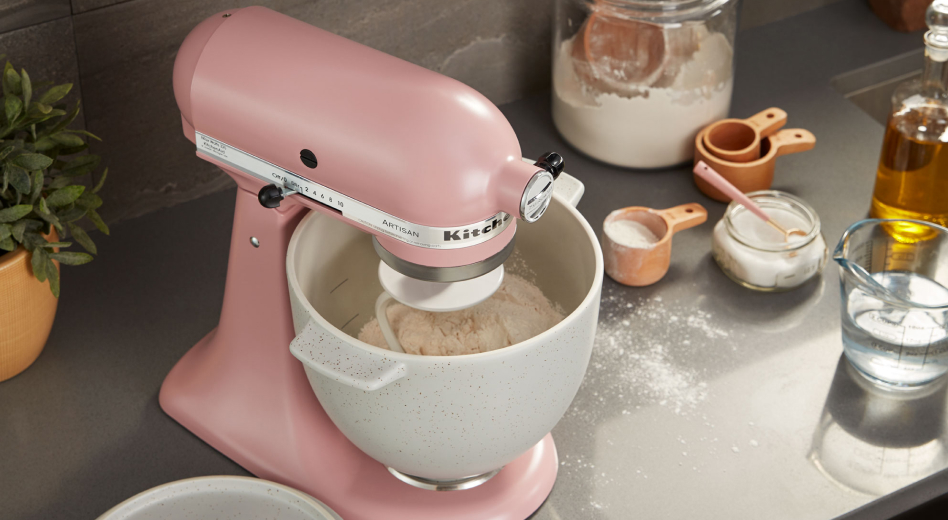 Silk Pink stand mixer kneading bread dough, surrounded by ingredients Silk Pink stand mixer kneading bread dough, surrounded by ingredients