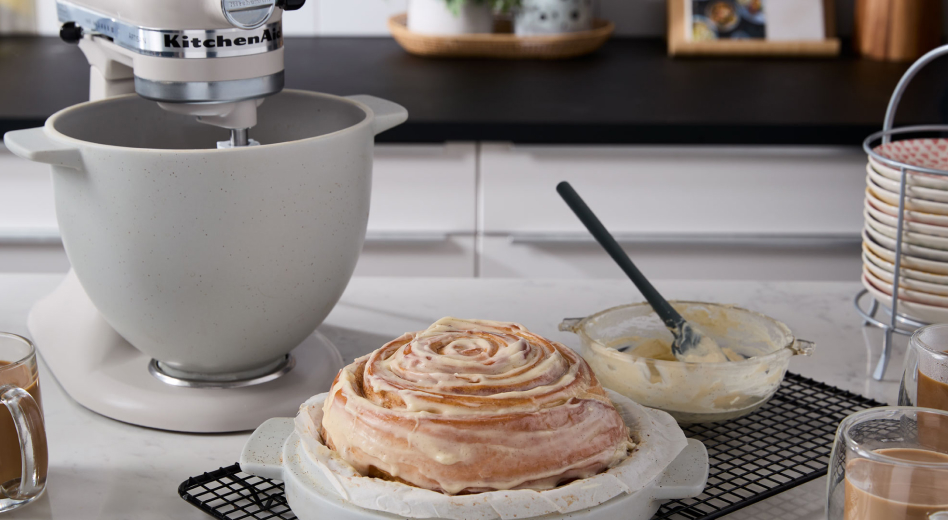 KitchenAid® stand mixer with Bread Bowl accessory next to cinnamon roll bread  KitchenAid® stand mixer with Bread Bowl accessory next to cinnamon roll bread