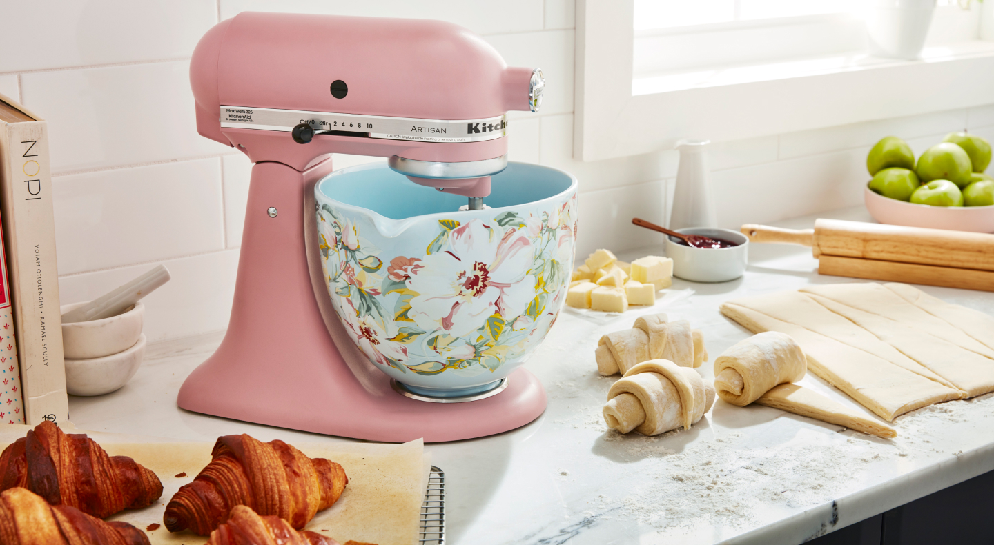 Pink KitchenAid® stand mixer with patterned bowl next to croissant dough Pink KitchenAid® stand mixer with patterned bowl next to croissant dough