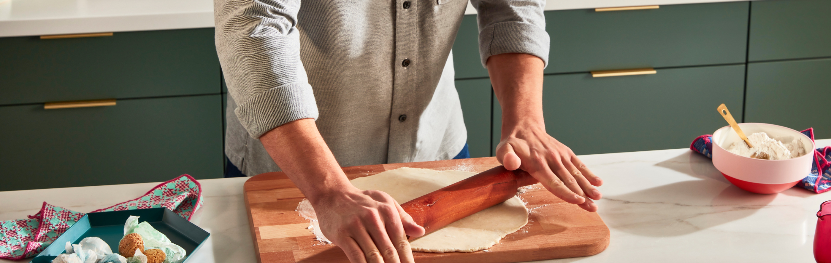 Person rolling out dough with a rolling pin
