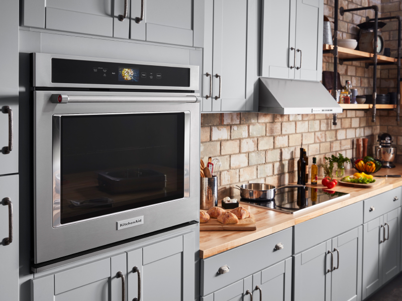 Stainless steel KitchenAid® wall oven in a rustic kitchen