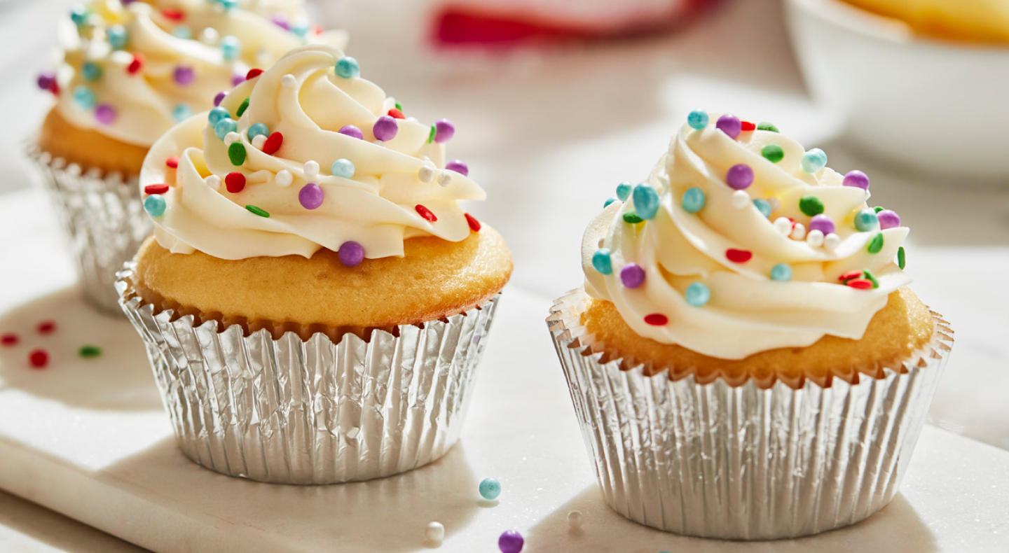 Cupcakes frosted with buttercream frosting and decorative sprinkles Cupcakes frosted with buttercream frosting and decorative sprinkles