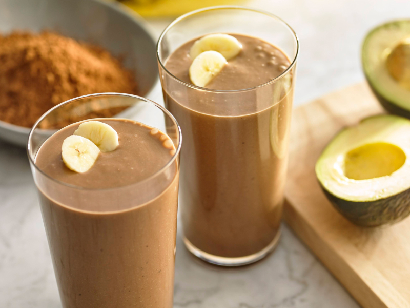 Glasses filled with blended chocolate drinks topped with fresh fruit Glasses filled with blended chocolate drinks topped with fresh fruit