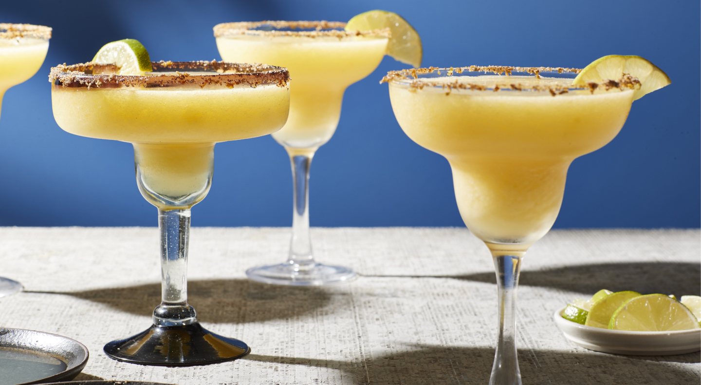 Mango margaritas in margarita glasses Mango margaritas in margarita glasses