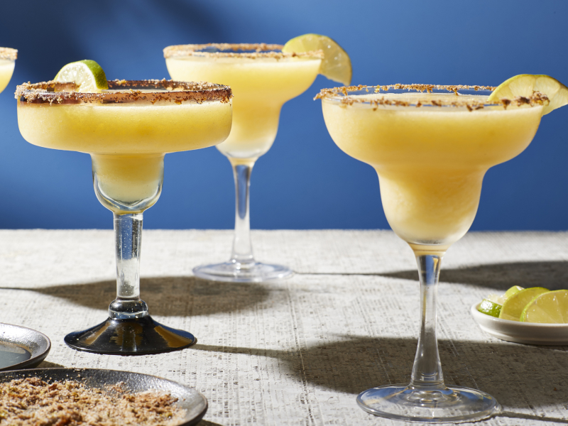 Mango margaritas in margarita glasses Mango margaritas in margarita glasses