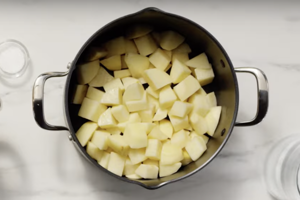Cubed, peeled potatoes in a saucepan