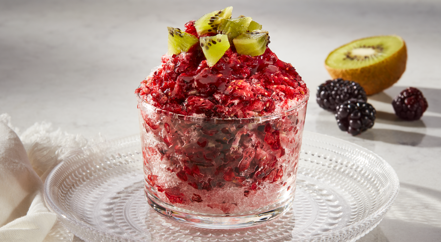 A dish of blackberry kiwi shave ice