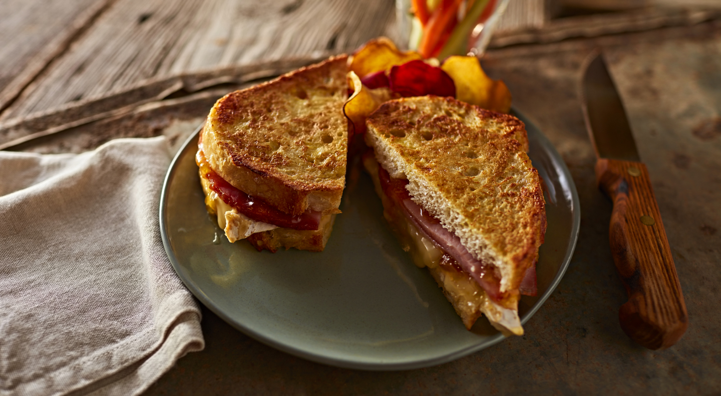 Syrupy ham French toast with fresh fruit on the side Syrupy ham French toast with fresh fruit on the side