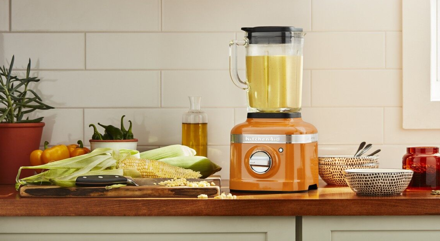 Food blending in an orange KitchenAid® blender Food blending in an orange KitchenAid® blender
