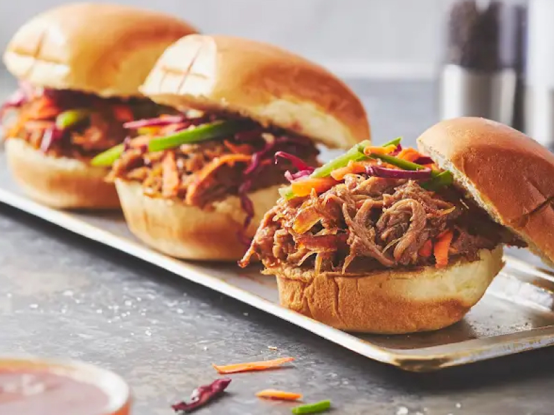Three pulled pork sandwiches on a plate Three pulled pork sandwiches on a plate