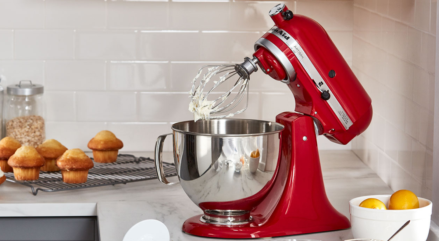 Red KitchenAid® stand mixer with stainless steel bowl and wire whisk attachment Red KitchenAid® stand mixer with stainless steel bowl and wire whisk attachment