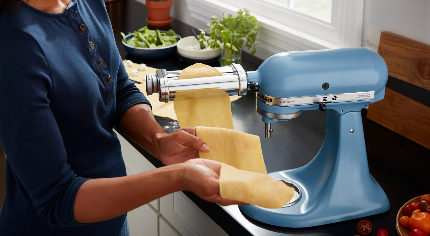 Man rolling pasta dough using the KitchenAid® pasta roller attachment Man rolling pasta dough using the KitchenAid® pasta roller attachment