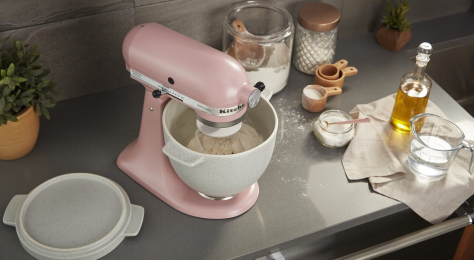 Woman filling a container with water from a refrigerator Stand mixer kneading sandwich bread dough