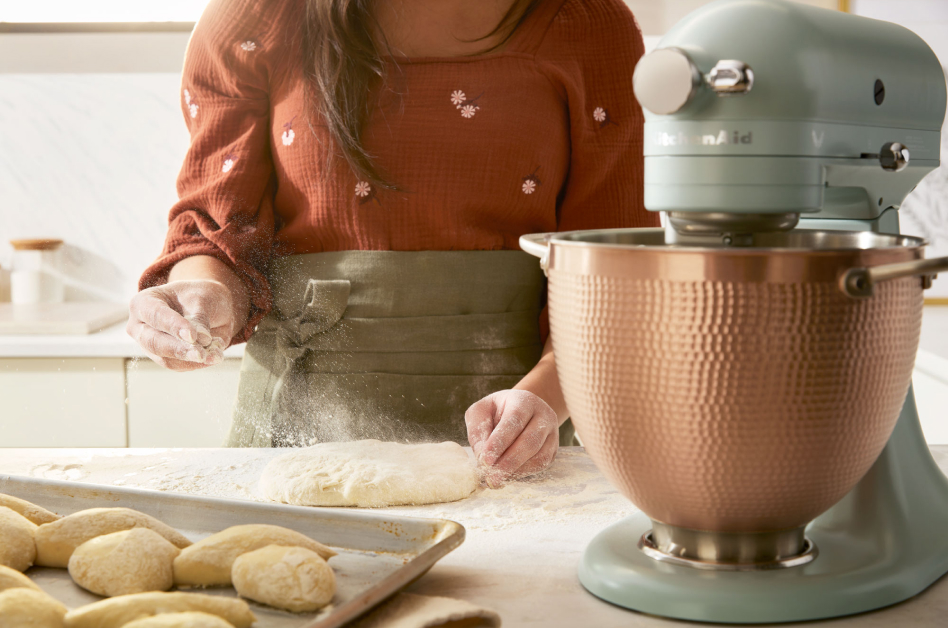 Scone dough being sprinkled with flour next to  KitchenAid® stand mixer Scone dough being sprinkled with flour next to  KitchenAid® stand mixer