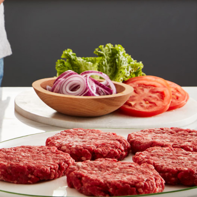 Ground meat patties and tomato, lettuce and onion