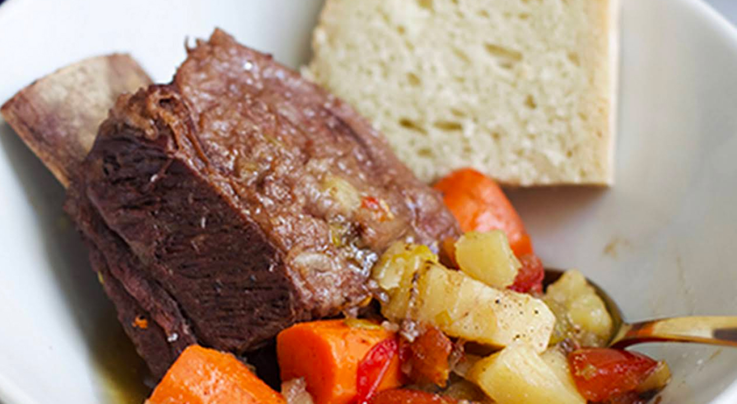 Short ribs with vegetables on plate with bread Short ribs with vegetables on plate with bread