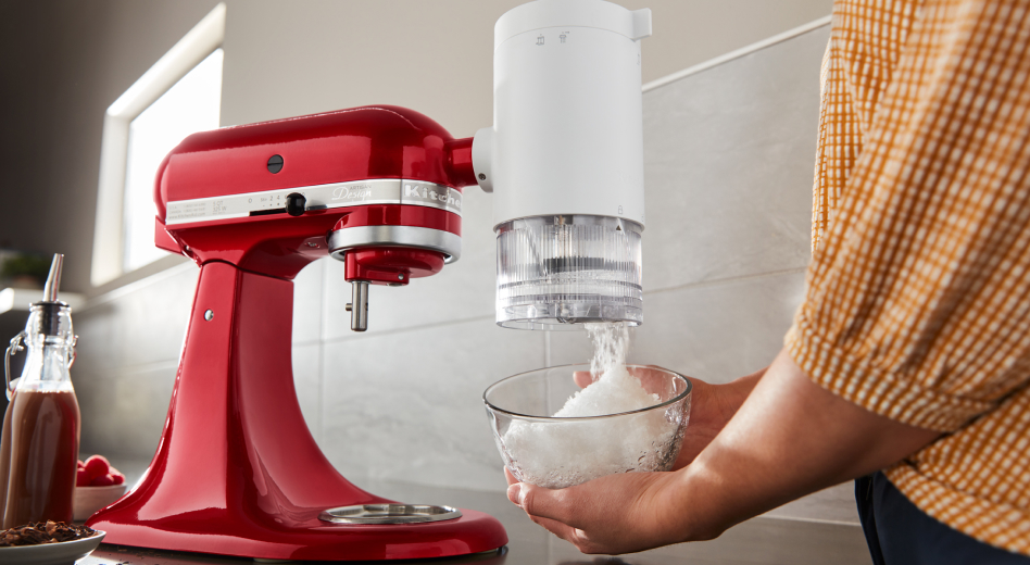 Ice being captured in bowl from KitchenAid® stand mixer with shave ice attachment Ice being captured in bowl from KitchenAid® stand mixer with shave ice attachment