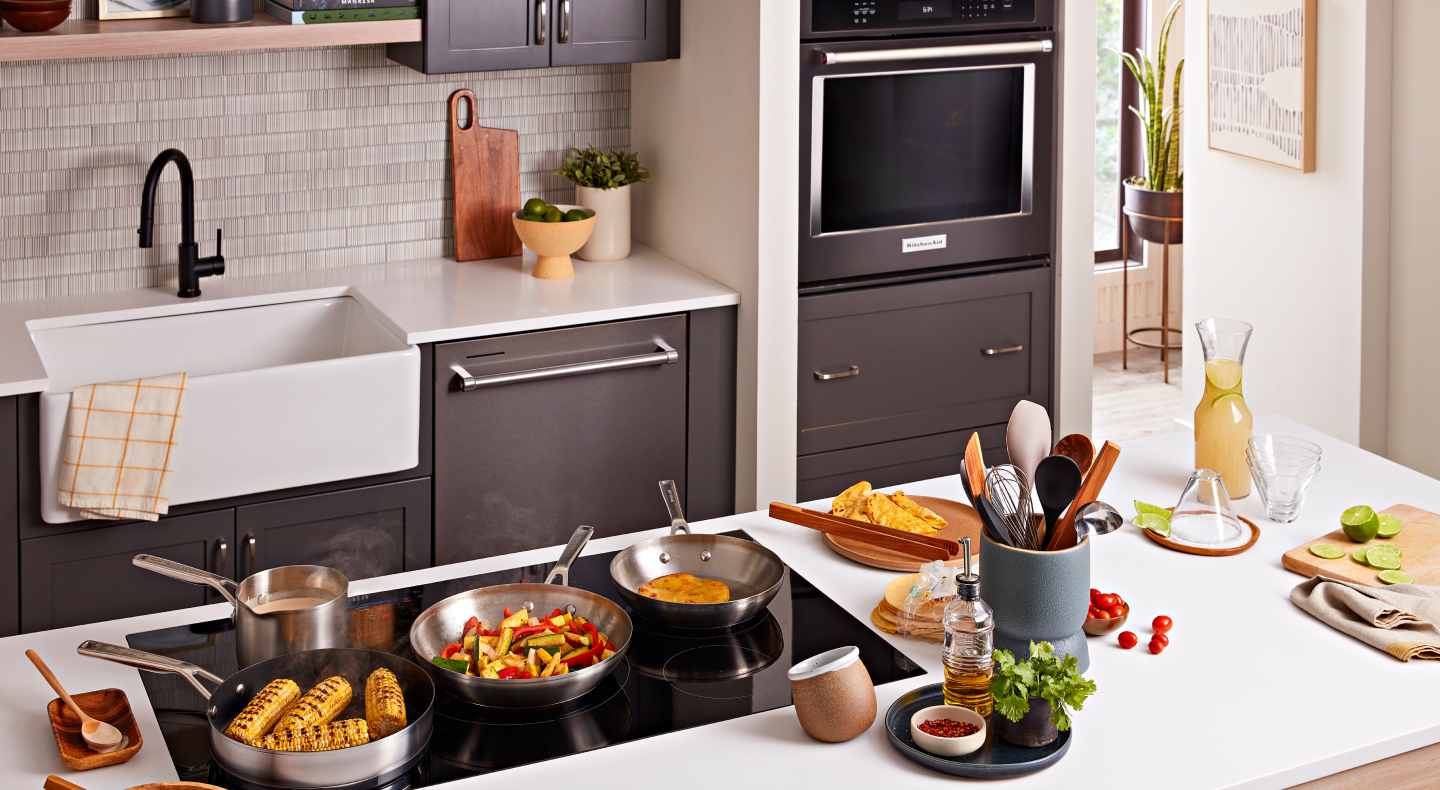 Several cooking stations making a meal featuring Spanish rice