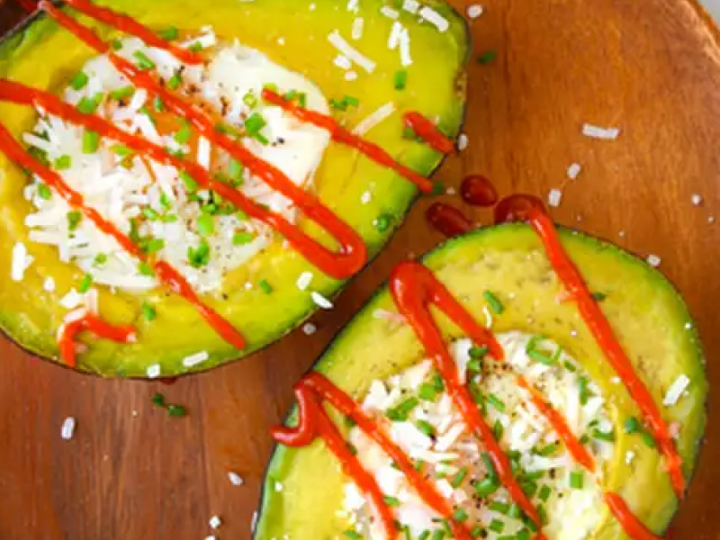 Baked avocado eggs with a drizzle of sriracha Baked avocado eggs with a drizzle of sriracha