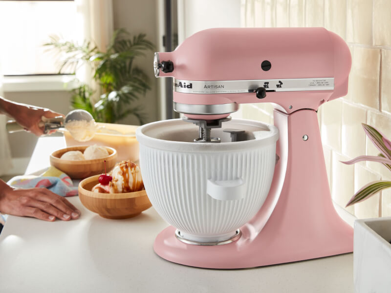 A KitchenAid® stand mixer on a countertop beside bowls of ice cream