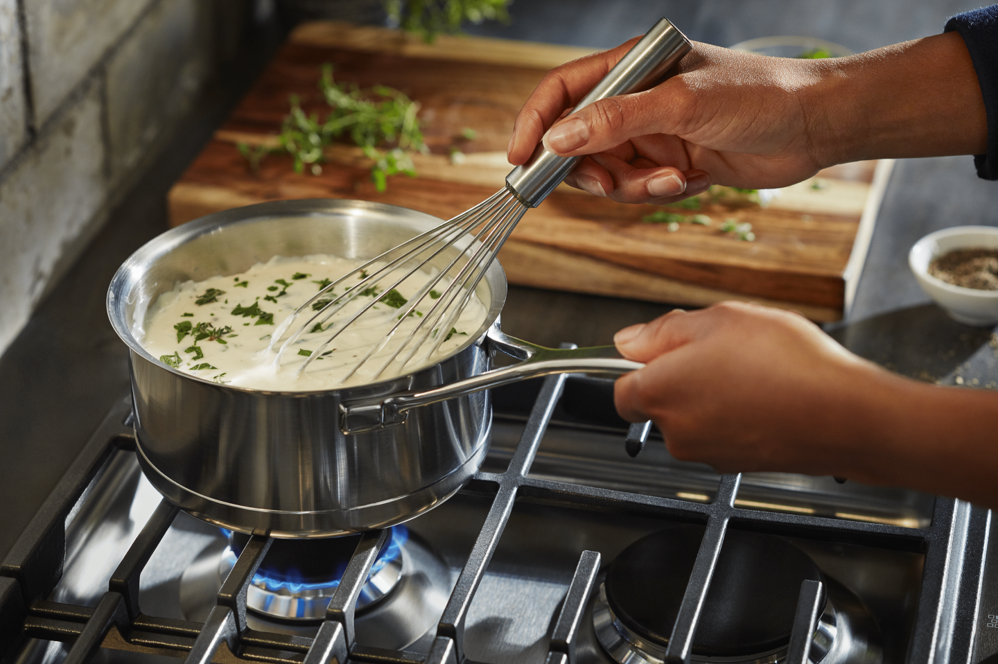 A pot of vegan queso simmering on the stove. A pot of vegan queso simmering on the stove.
