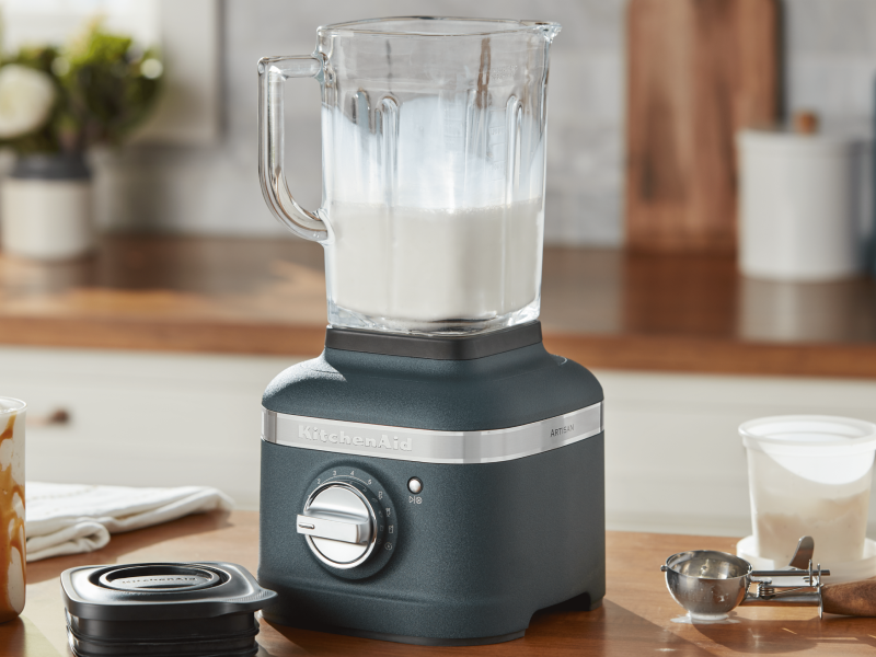 A person using a KitchenAid® blender.
