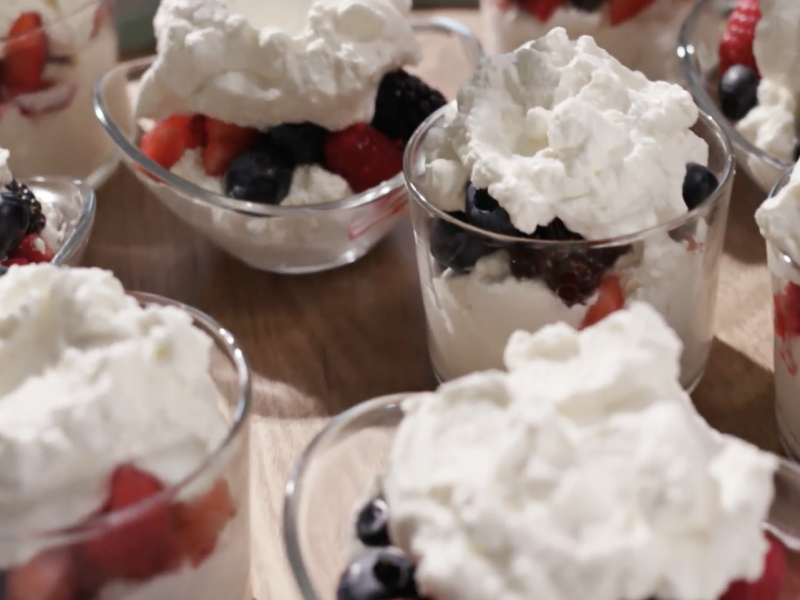 Berry and yogurt parfait desserts with whipped cream topping Berry and yogurt parfait desserts with whipped cream topping