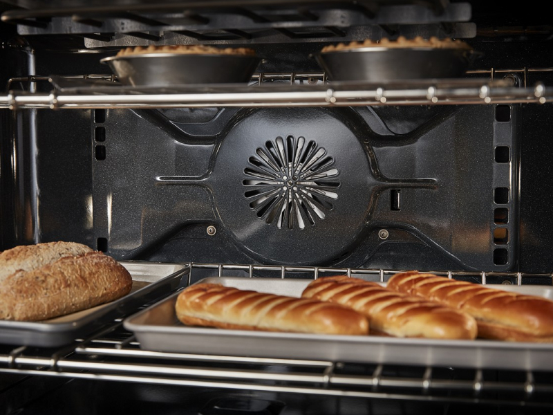 Close-up of bread and pies baking inside of an oven cavity