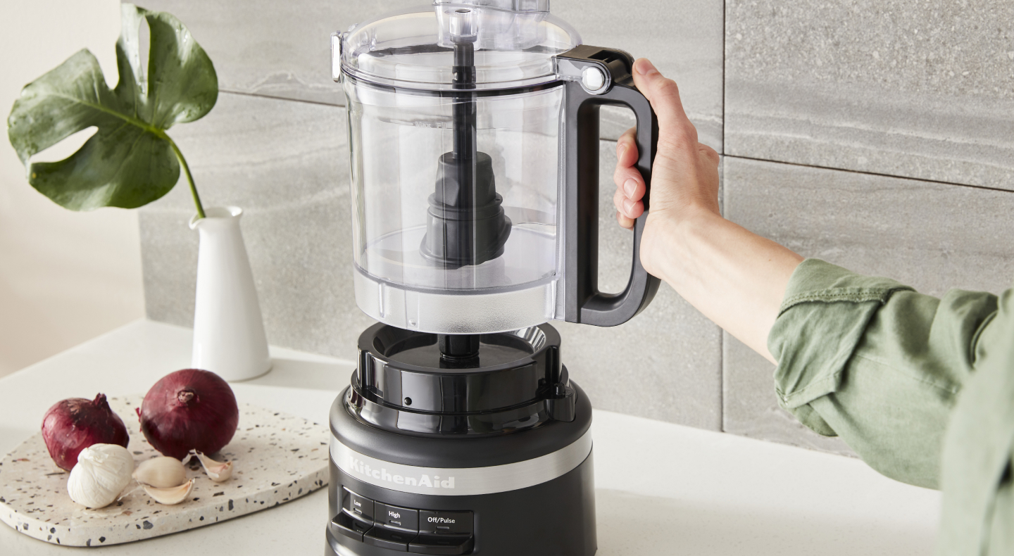 A work bowl being locked into a food processor base A work bowl being locked into a food processor base