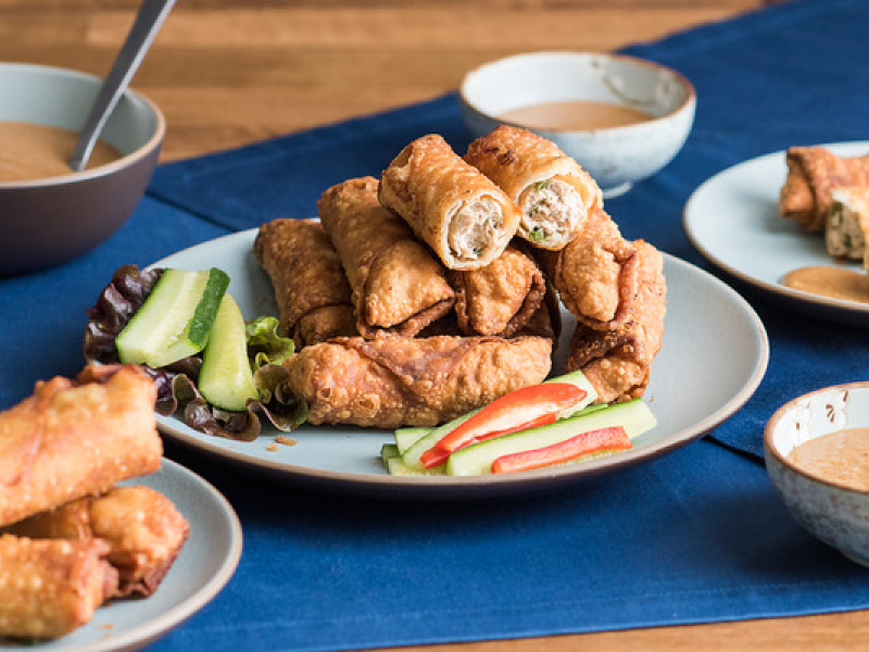 A plate of eggrolls containing minced chicken A plate of eggrolls containing minced chicken