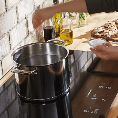 Pot of water boiling on an electric cooktop