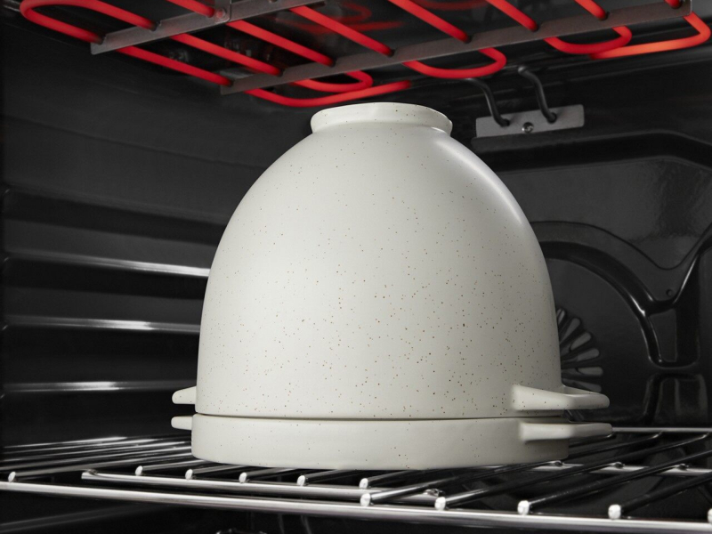 Bread proofing bowl with the lid on in the oven