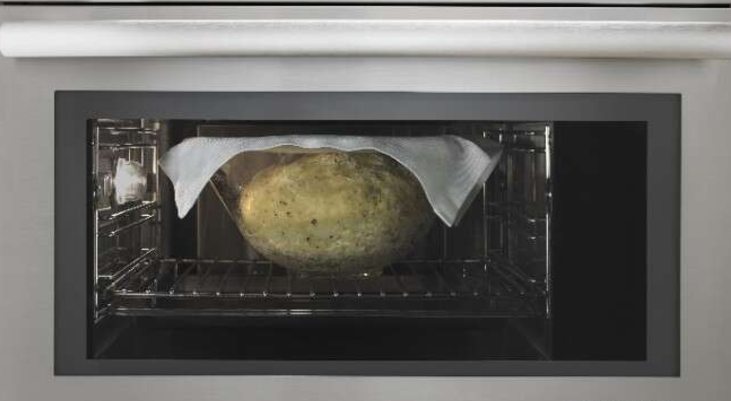 Bread rising in a glass bowl, with a cloth on top, inside of a convection microwave Bread rising in a glass bowl, with a cloth on top, inside of a convection microwave