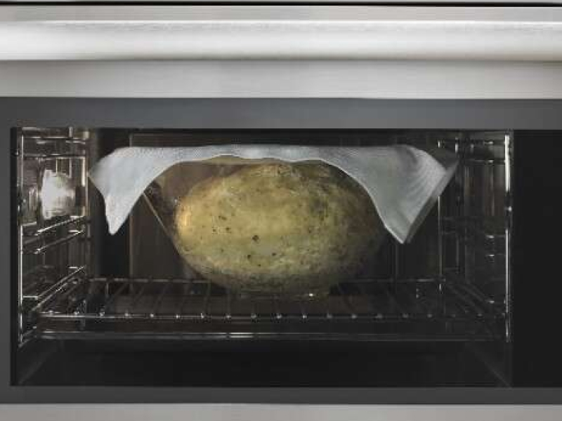 Bread rising in a glass bowl, with a cloth on top, inside of a convection microwave Bread rising in a glass bowl, with a cloth on top, inside of a convection microwave
