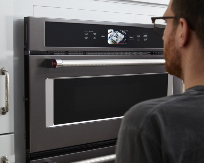 Person standing in front of a wall oven
