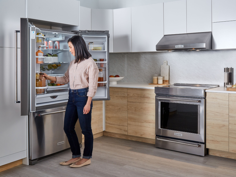 Person removing item from KitchenAid® refrigerator Person removing item from KitchenAid® refrigerator