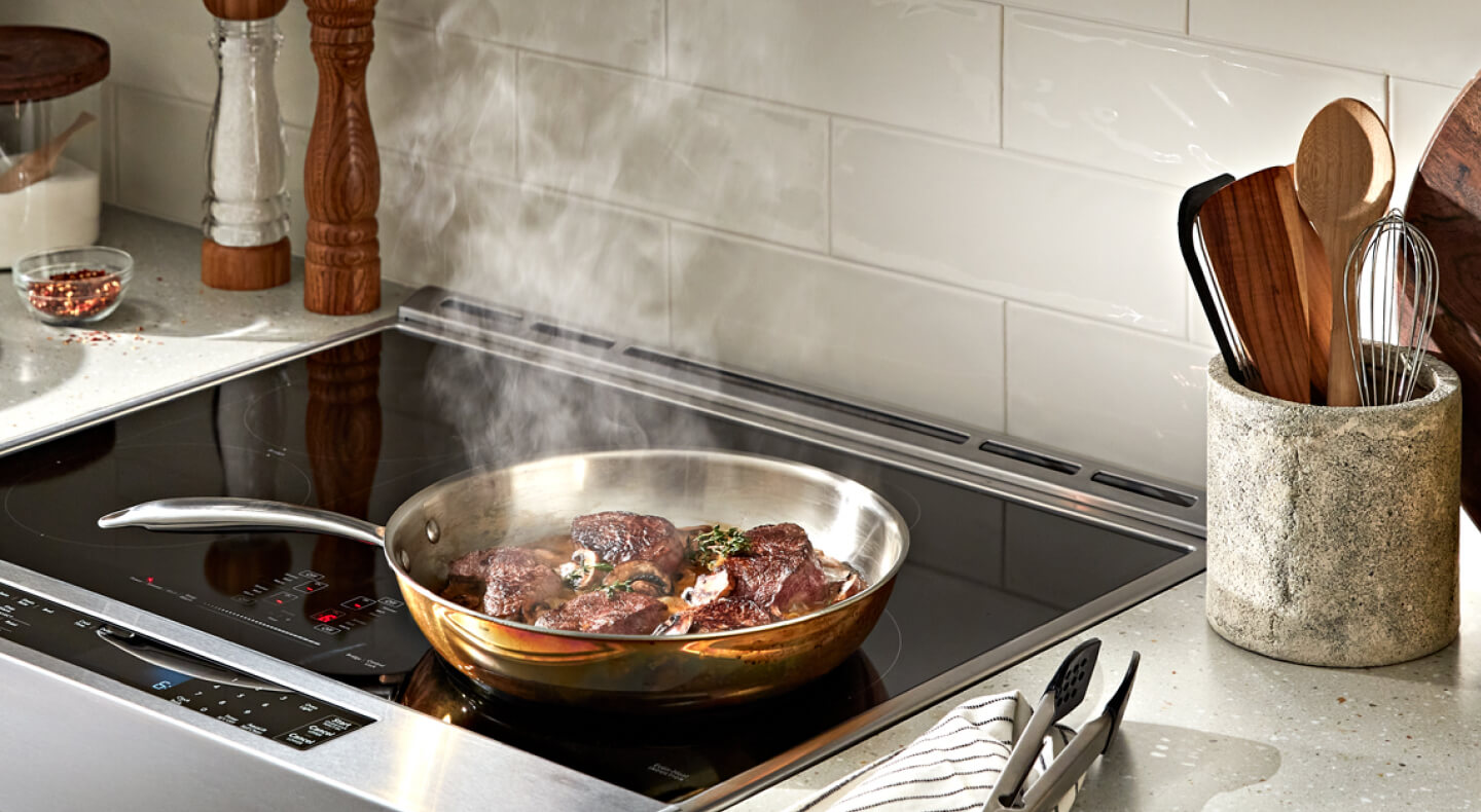Steak cooking on a cooktop Steak cooking on a cooktop